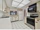 Condo kitchen with white cabinets, tile floor, and stainless steel appliances at 3438 Wood Owl Cir # 275, Bradenton, FL 34210