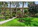 Condo building, walkway, tropical landscaping, and lush green grass at 3438 Wood Owl Cir # 275, Bradenton, FL 34210