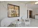White wicker chairs and small table on a screened porch at 3438 Wood Owl Cir # 275, Bradenton, FL 34210