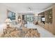 Condo living room with patio access, featuring comfortable seating and built-in shelving at 3438 Wood Owl Cir # 275, Bradenton, FL 34210