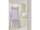 Bright condo entryway with tile flooring leading to a white door and kitchen at 3438 Wood Owl Cir # 275, Bradenton, FL 34210
