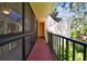 Screened balcony with tiled floor, railing, and sliding glass doors at 3438 Wood Owl Cir # 275, Bradenton, FL 34210
