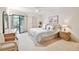 Spacious main bedroom with a king-size bed and access to a private balcony at 3438 Wood Owl Cir # 275, Bradenton, FL 34210