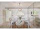 Condo dining area with glass table and chairs, view to kitchen at 3438 Wood Owl Cir # 275, Bradenton, FL 34210