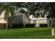 Backyard view of house with screened patio and green lawn at 7421 Fairlinks Ct, Sarasota, FL 34243