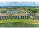 Condo building overlooking a lake with a pool at 16904 Vardon Ter # 108, Bradenton, FL 34211