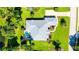 Aerial view of home highlighting the pool, lush landscaping, and manicured lawn at 7430 Weeping Willow Dr, Sarasota, FL 34241