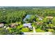 Aerial view of the home featuring lush, green foliage surrounding the property and a serene water view at 7430 Weeping Willow Dr, Sarasota, FL 34241