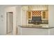 Elegant bar area with granite countertops and custom cabinetry at 7430 Weeping Willow Dr, Sarasota, FL 34241