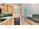Charming bar area with ample counter space and decorative backsplash at 7430 Weeping Willow Dr, Sarasota, FL 34241