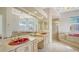 Bathroom with a large mirror, dual sinks, vanity and glass enclosed shower and an adjacent jetted tub at 7430 Weeping Willow Dr, Sarasota, FL 34241