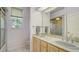 Bright bathroom with double sinks, a large mirror, and a shower/tub combination at 7430 Weeping Willow Dr, Sarasota, FL 34241