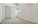 Simple bedroom featuring a ceiling fan, neutral carpeting, and a closet at 7430 Weeping Willow Dr, Sarasota, FL 34241