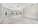 Large bedroom with tray ceiling and bright windows overlooking the property at 7430 Weeping Willow Dr, Sarasota, FL 34241