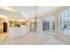 Bright dining area with stylish chandelier and sliding doors to the lanai at 7430 Weeping Willow Dr, Sarasota, FL 34241