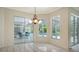 Open dining area with windows overlooking pool and lanai at 7430 Weeping Willow Dr, Sarasota, FL 34241