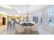 Bright dining area with stylish chandelier and sliding doors to the lanai at 7430 Weeping Willow Dr, Sarasota, FL 34241