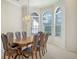 Bright dining room featuring elegant chandelier and arched windows at 7430 Weeping Willow Dr, Sarasota, FL 34241