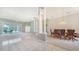 Spacious living area with columns, chandelier, and poolside access at 7430 Weeping Willow Dr, Sarasota, FL 34241
