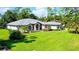 Spacious home with manicured lawn and palm trees at 7430 Weeping Willow Dr, Sarasota, FL 34241