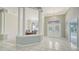 Elegant foyer featuring marble floors, chandeliers, and columns at 7430 Weeping Willow Dr, Sarasota, FL 34241