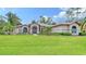 Stunning home showcasing a well-manicured lawn and beautiful landscaping at 7430 Weeping Willow Dr, Sarasota, FL 34241