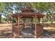 Wooden gazebo with benches, shaded by trees at 7430 Weeping Willow Dr, Sarasota, FL 34241