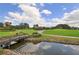 Picturesque golf course with water feature and bridge at 7430 Weeping Willow Dr, Sarasota, FL 34241