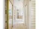 Hallway featuring a mirrored closet with sliding doors, built-in shelving and access to a bathroom at 7430 Weeping Willow Dr, Sarasota, FL 34241
