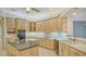 Gourmet kitchen features granite counters, an island, and stainless steel appliances at 7430 Weeping Willow Dr, Sarasota, FL 34241