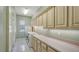 Spacious laundry room featuring a sink, built-in cabinets, and a washer and dryer at 7430 Weeping Willow Dr, Sarasota, FL 34241
