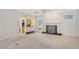 Open-concept living room with fireplace and adjacent bar area at 7430 Weeping Willow Dr, Sarasota, FL 34241