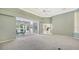 Spacious living room with sliding doors to lanai and french doors to another living area at 7430 Weeping Willow Dr, Sarasota, FL 34241