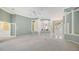 Large open living room with columns, tile floors, and an open floorplan at 7430 Weeping Willow Dr, Sarasota, FL 34241