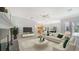 Bright living room with fireplace, comfortable seating, and access to the outdoor area at 7430 Weeping Willow Dr, Sarasota, FL 34241