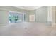 Open living area with large windows offering views of the screened pool patio at 7430 Weeping Willow Dr, Sarasota, FL 34241