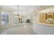Open concept living space with fireplace, wet bar, and tile flooring at 7430 Weeping Willow Dr, Sarasota, FL 34241