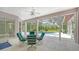 Covered outdoor seating with table and chairs overlooks the screened-in pool and backyard at 7430 Weeping Willow Dr, Sarasota, FL 34241