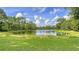 Picturesque view of a tranquil pond surrounded by lush greenery, offering a serene and natural setting at 7430 Weeping Willow Dr, Sarasota, FL 34241