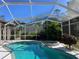 Screened pool and spa with some damage to screen at 7430 Weeping Willow Dr, Sarasota, FL 34241