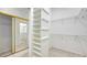 Well-organized walk-in closet with adjustable shelving and hanging rods for optimal storage at 7430 Weeping Willow Dr, Sarasota, FL 34241