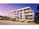 Beachfront building with pool and outdoor patio area at 70 Avenida Veneccia # 402, Sarasota, FL 34242