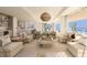 Open-concept living room with kitchen and dining area at 70 Avenida Veneccia # 402, Sarasota, FL 34242