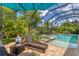Relaxing poolside patio with lounge chairs and umbrella at 7336 Haddington Cv, Bradenton, FL 34202