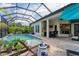 Luxury backyard with pool, patio, and outdoor kitchen at 7336 Haddington Cv, Bradenton, FL 34202