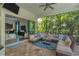 Covered lanai with sectional sofa and view into the home at 7336 Haddington Cv, Bradenton, FL 34202