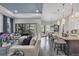 Open living room with a view of the pool and kitchen at 7336 Haddington Cv, Bradenton, FL 34202