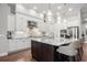 Gourmet kitchen with large island, stainless steel appliances, and white cabinets at 7336 Haddington Cv, Bradenton, FL 34202
