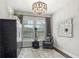 Charming home office features a comfortable armchair, large mirror, and ample natural light at 7336 Haddington Cv, Bradenton, FL 34202