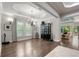 Elegant dining room with hardwood floors, chandelier, and large windows at 7336 Haddington Cv, Bradenton, FL 34202